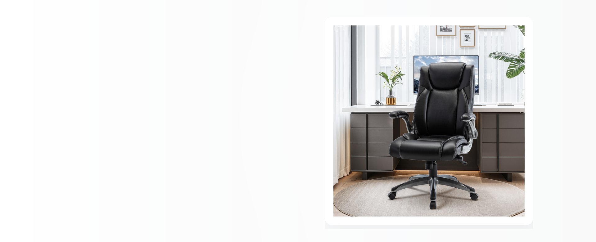 A black leather executive office chair in a room, beside a desk and a plant.
